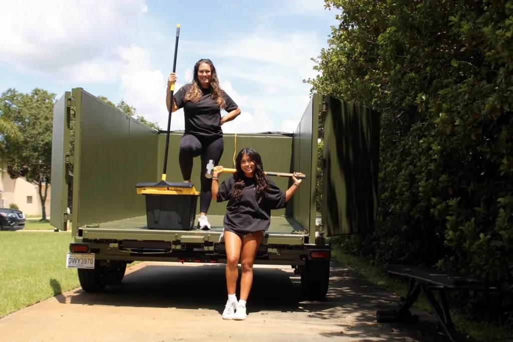 Dumpster Crews team working inside a dumpster trailer with tools for junk removal service