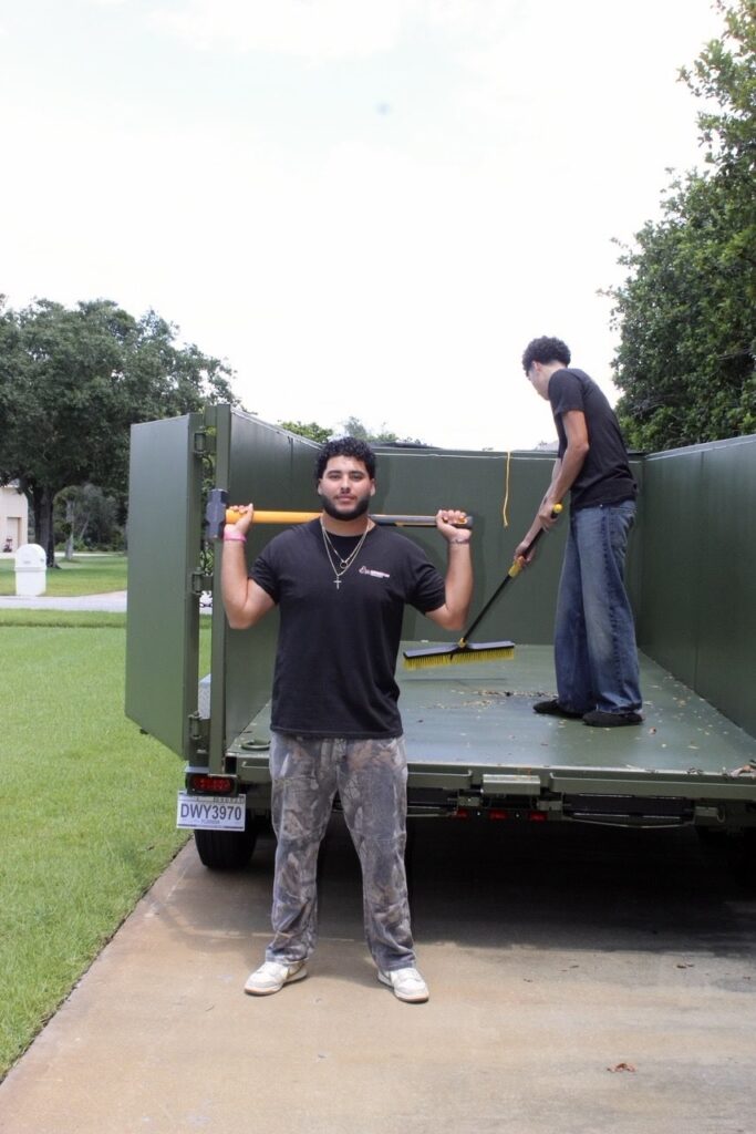 Dumpster Crews team cleaning a dumpster trailer during junk removal service in Central Florida